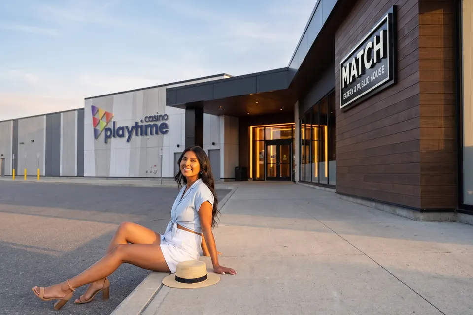 Woman outside Playtime Casino Wasaga Beach at golden hour